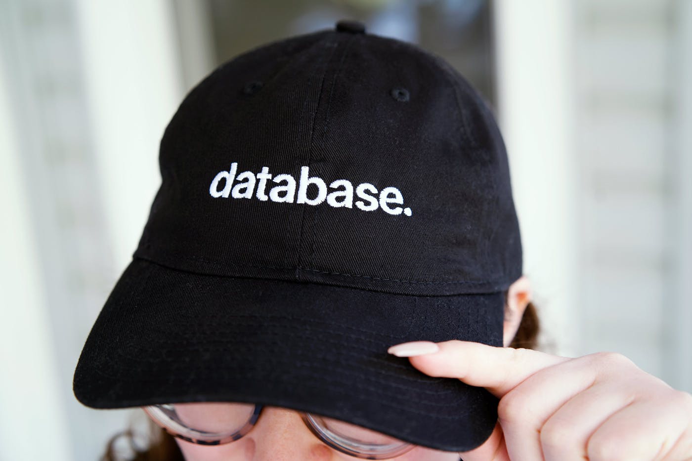 Black baseball cap with “database.” embroidery